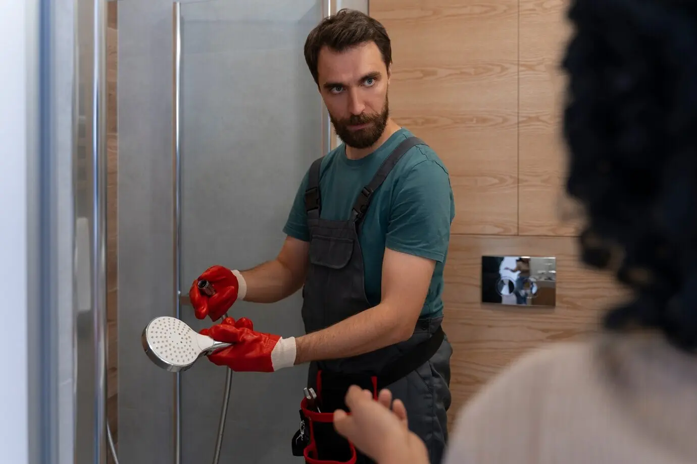 Side view of a man working as a plumber.
