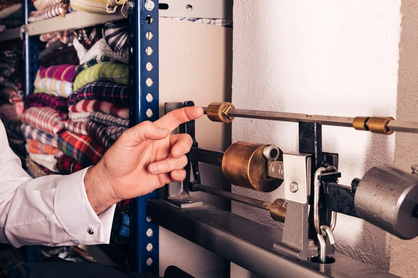Close-up view of a man's hand touching the vintage machine.
